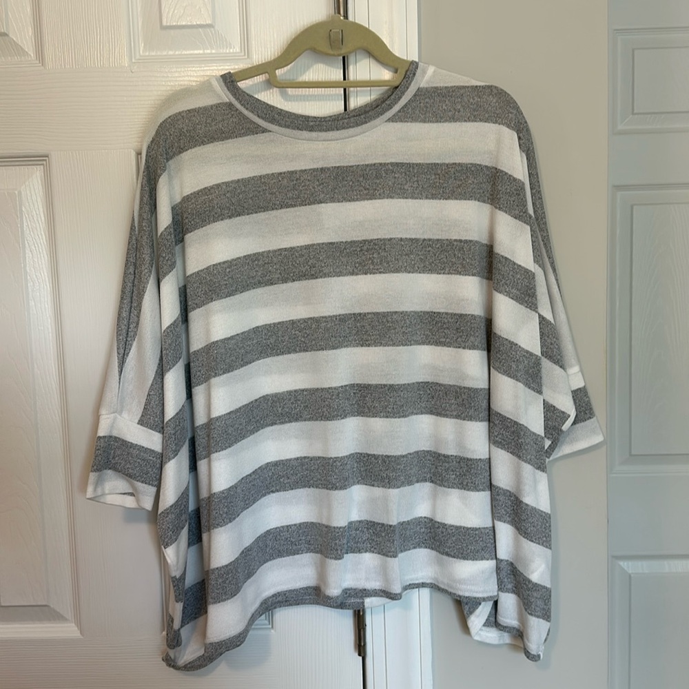Grey and white striped quart length sleeve poncho